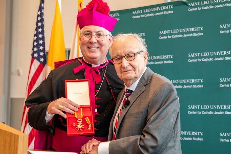 CCJS co-founder recognized by the pope Rabbi Rudin posing with Bishop Mark O’Connell and his medal of the Order of St. Gregory.