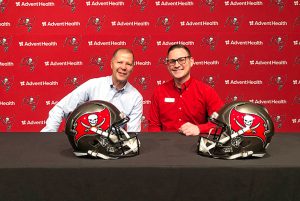 Alumni photo op at Bucs training facility tour alumni event.